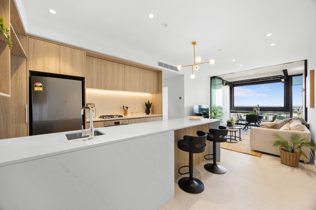 Kitchen with stone island in apartment 2405